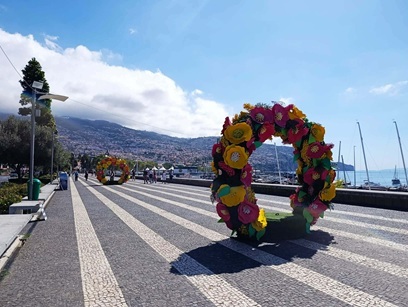 Impressive floral displays at the harbour in Funchal during the Flower Festival The harbourfront in Funchal is decorated with giant floral sculptures and installations to mark the Madeira Flower Festival. In the background are moored ships and boats, along with the city’s distinctive architecture.